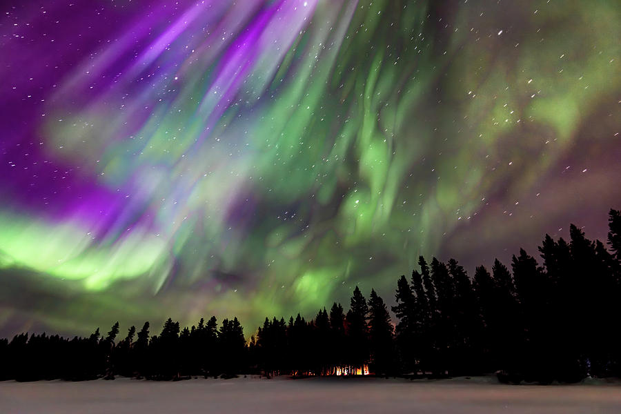 Vivid Aurora also called the Northern Lights over a cabin in a snow ...