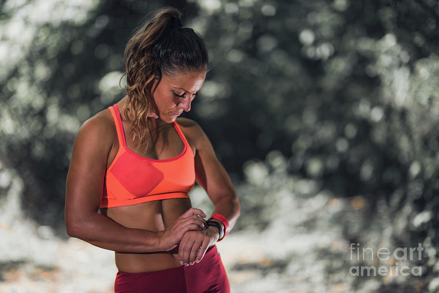 Woman Looking At Smartwatch During Workout #9 Photograph by Microgen Images/science Photo Library