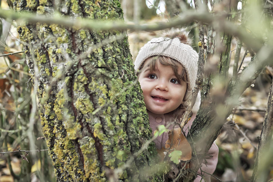 Fantasy Photograph - A 2 Year Old Girl In Nature With Her Woolen Hat by Cavan Images