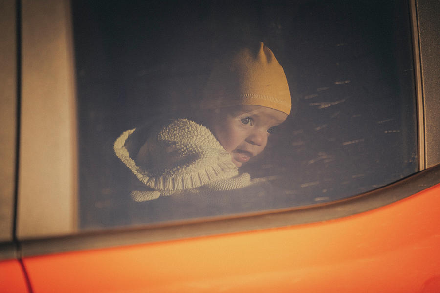Transportation Photograph - A Baby Is Looking Through A Car Window, Monument Valley, Arizona by Cavan Images