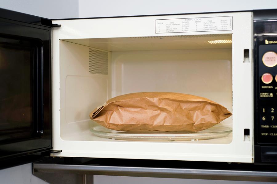 A Bag Of Popcorn In A Microwave Photograph by Jim Scherer
