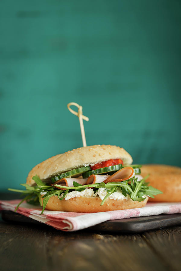 A Bagel Sandwich With Smoked Turkey Breast, Rocket And Cucumbers Photograph by Valeria Aksakova