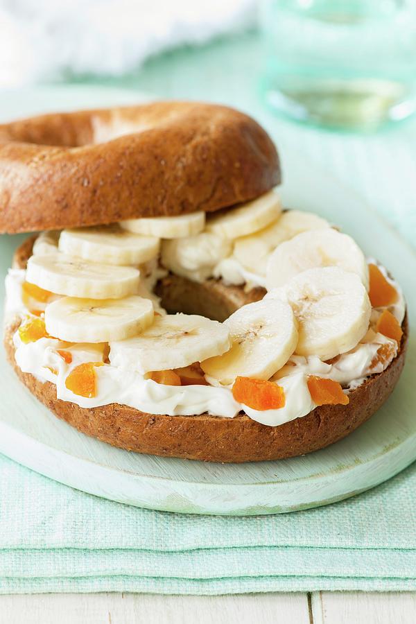 A Bagel With Quark, Dried Apricots, And Sliced Banana Photograph by Jonathan Short
