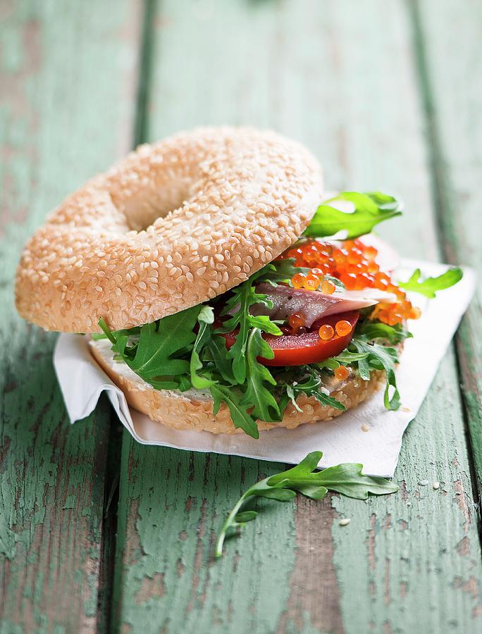 A Bagel With Trout Fillet, Tomatoes And Rocket Photograph by Ewgenija Schall