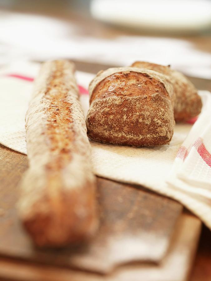 Bread Photograph - A Baguette And Bread Rolls by Till Melchior