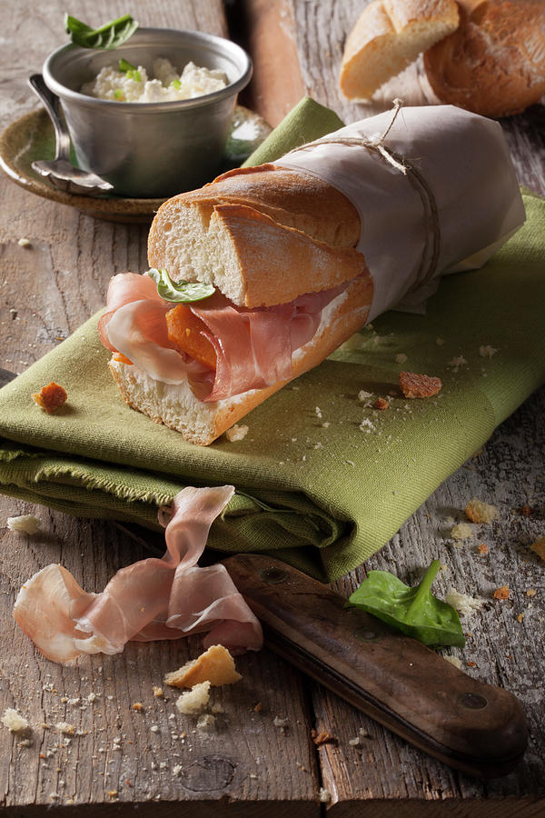 A Baguette Sandwich With Parma Ham, Spinach And Cream Cheese Photograph by Blueberrystudio