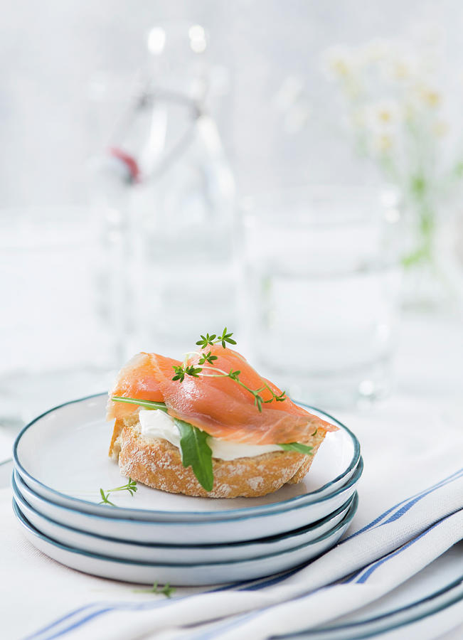 A Baguette Slice Covered With Smoked Salmon On A Stack Of Plates Photograph by Jennifer Braun
