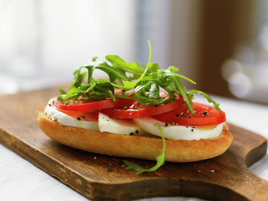 A Baguette Slice Topped With Mozzarella, Tomatoes And Rocket Photograph by Jim Scherer