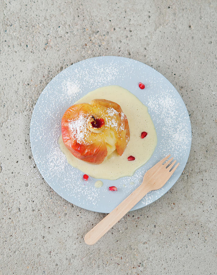 A Baked Apple With Vanilla Sacue And Pomegranate Seeds seen From Above Photograph by Udo Einenkel