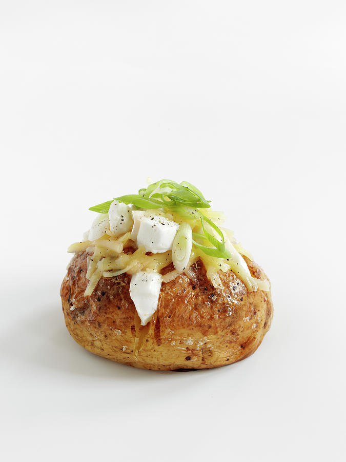 A Baked Potato With Cheese And Spring Onions Photograph by Gareth Morgans