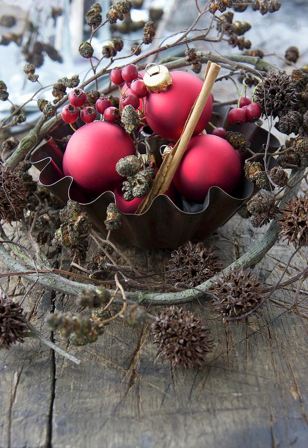 A Baking Tin With Red Christmas Tree Baubles, Hawthorn Berries, Alderberry Sprigs And Maple Berry Sprigs Photograph by Martina Schindler