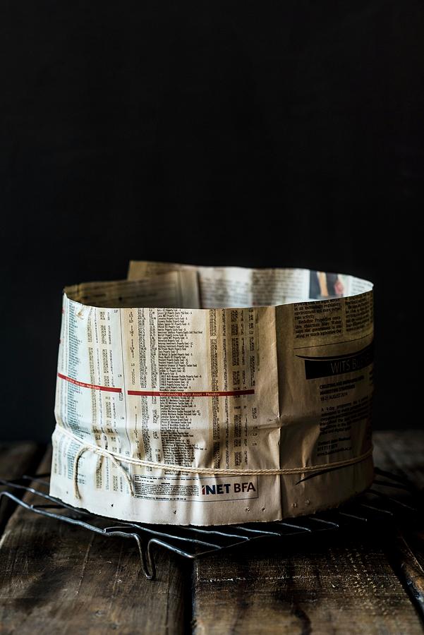 A Baking Tin Wrapped In Newspaper For A Spelt And Amaretto Fruit Cake Photograph by Hein Van Tonder