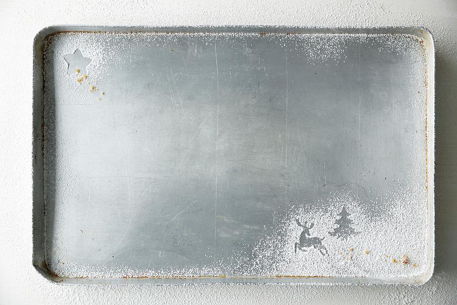 A Baking Tray With Christmas Shapes Dusted In Icing Sugar Photograph by Mona Binner Photographie