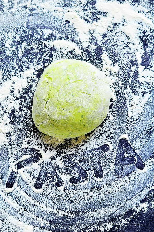 A Ball Of Green Pasta Dough On A Floured Work Surface With The Word Pasta Written With A Finger In The Flour Photograph by Jamie Watson