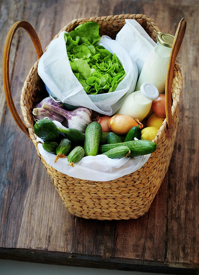 A Basket Bag With Lettuce, Vegetables, Lemons, Milk, Cream And Oatmeal Photograph by Stefan Schulte-ladbeck