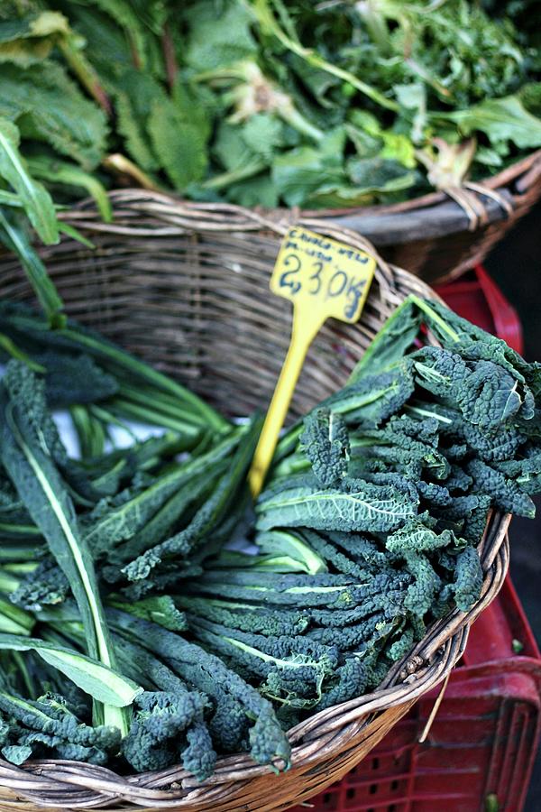 A Basket Of Black Cabbage At A Market Photograph by Alexandra Panella