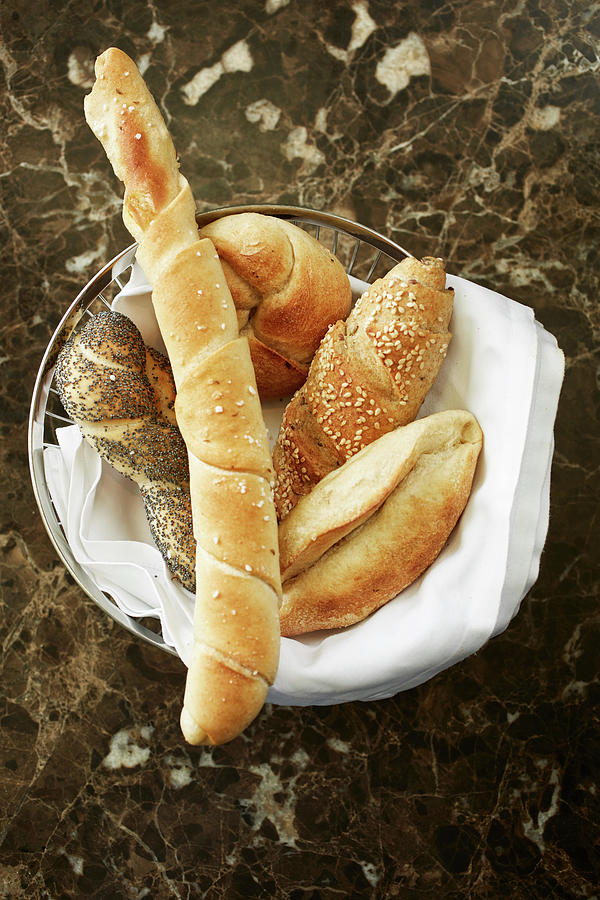 A Basket Of Bread On A Marble Table Photograph by Herbert Lehmann