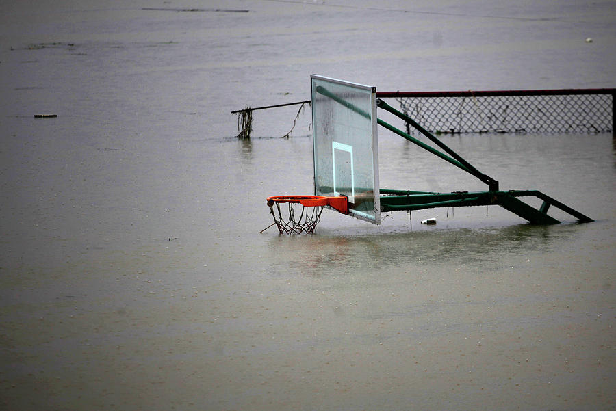 A Basketball Court is Covered by Water Photograph by Carlos Barria