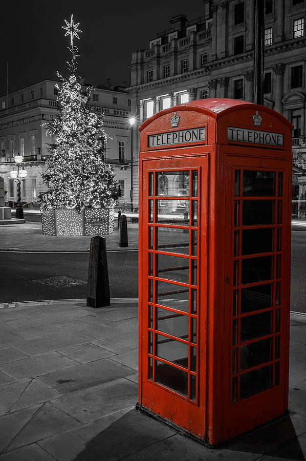 A beautiful red phone booth in London, England, during Christmas. Photograph by George Afostovremea