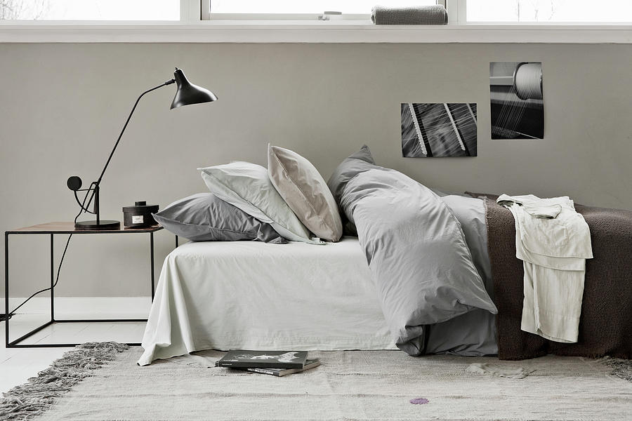 A Bed With A Duvet And Pillows And A Bedside Table With A Reading Lamp Photograph by Lykke Foged & Morten Holtum