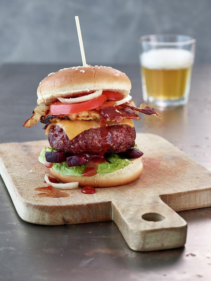 A Beef Burger With Cheddar, Bacon And Bbq Sauce Photograph by Julia Hildebrand