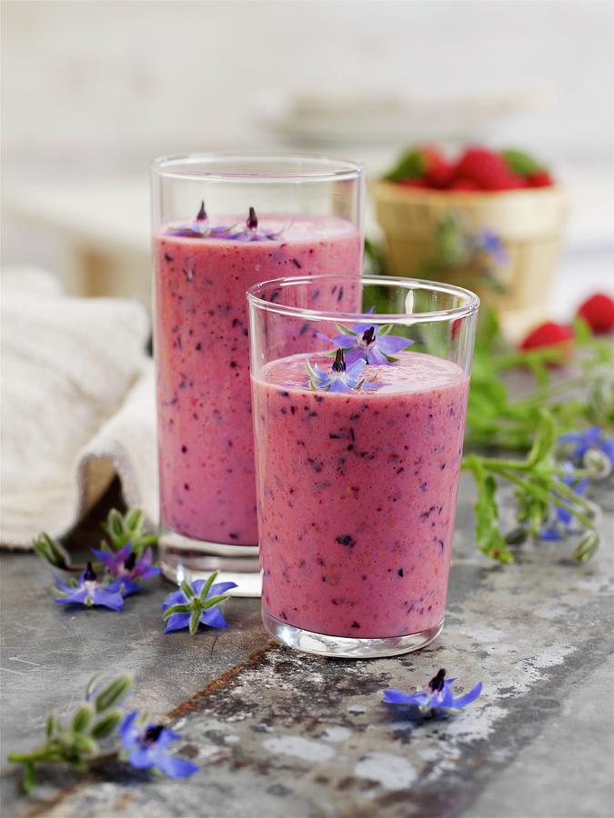 A Berry And Banana Shake With Apples And Borage Flowers Photograph by Garlick, Ian