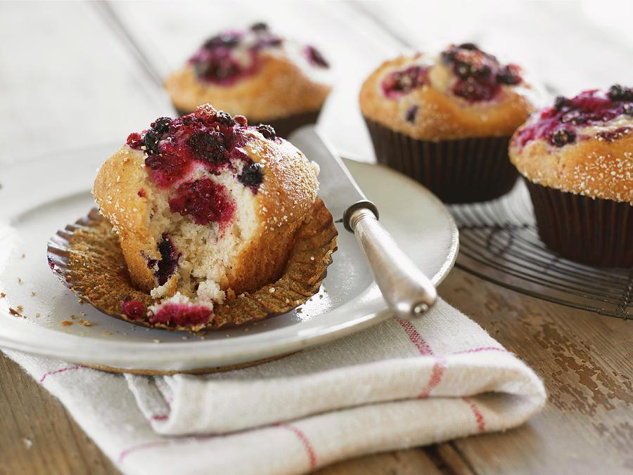A Berry Muffin In A Paper Case, With A Bite Missing Photograph by West, Stuart