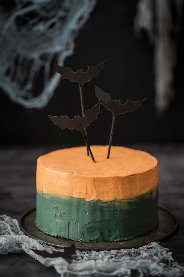A Bi-coloured Halloween Cake Decorated With Bats Photograph by Malgorzata Laniak