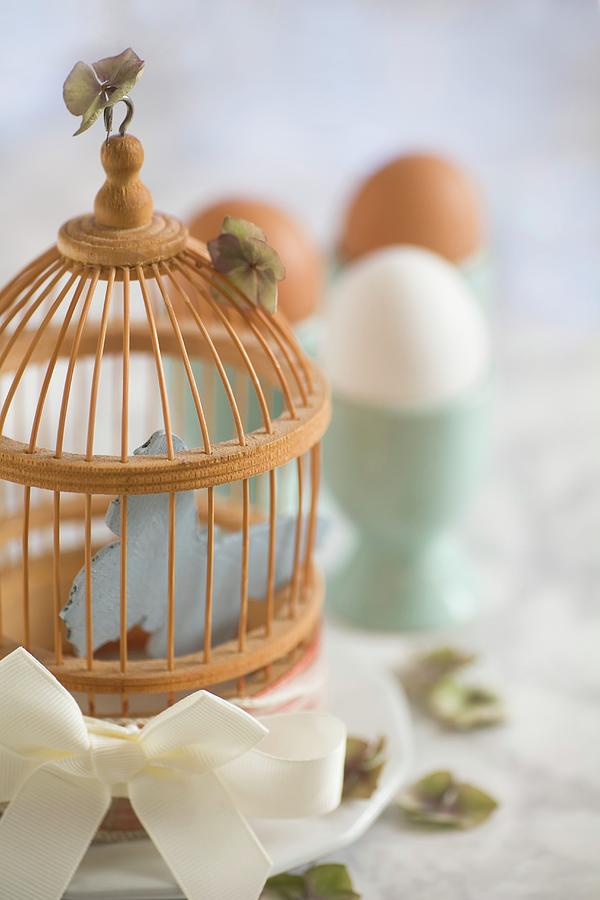 A Bird Cage As Easter Decoration On A Breakfast Table Photograph by Alicja Koll