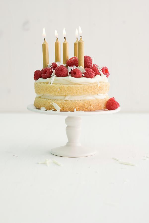 A Birthday Cream Cake With Raspberries And Golden Candles Photograph by Michael Wissing
