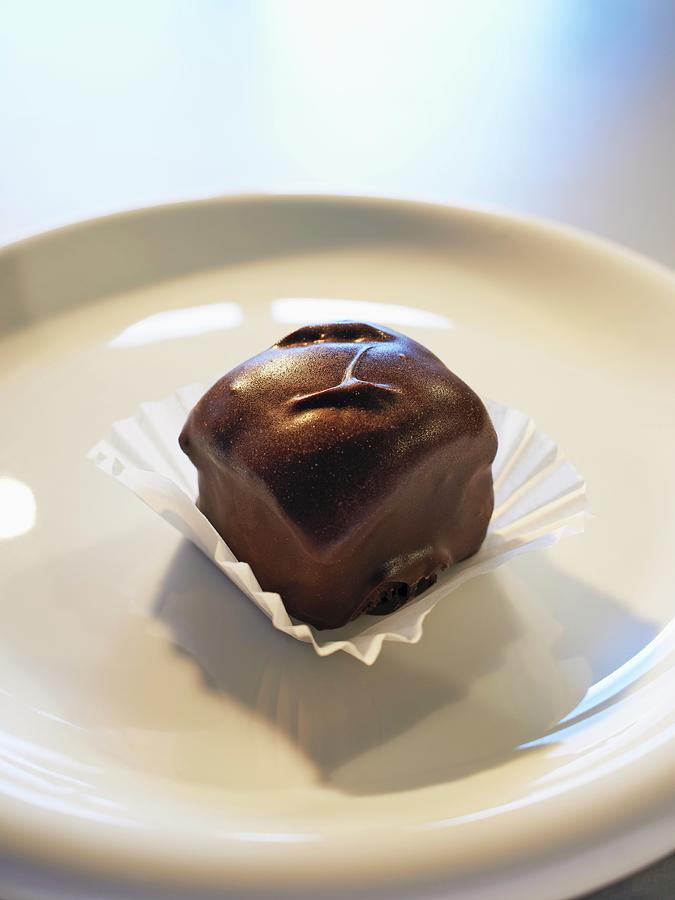 A Bite-sized Brownie With Dark Chocolate Glaze Photograph by Oliver Lippert