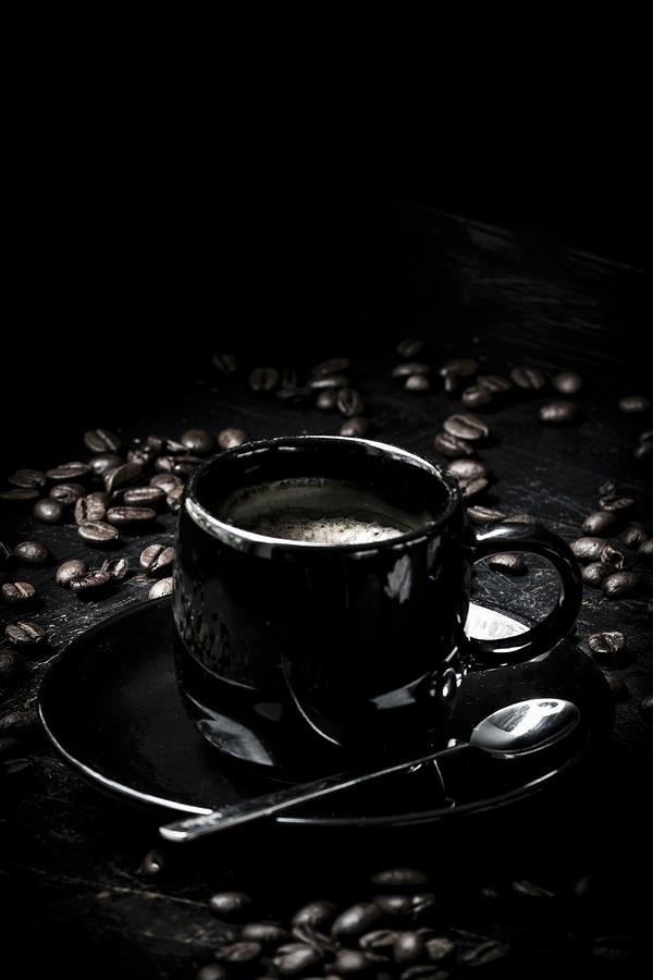 A Black Espresso Cup With Espresso Beans Photograph by Charlotte Von Elm