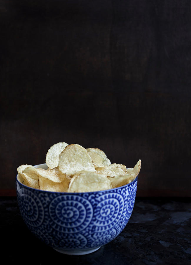 A Blue And White Bowl With Chips, Sitting On A Dark Countertop Photograph by Ryla Campbell