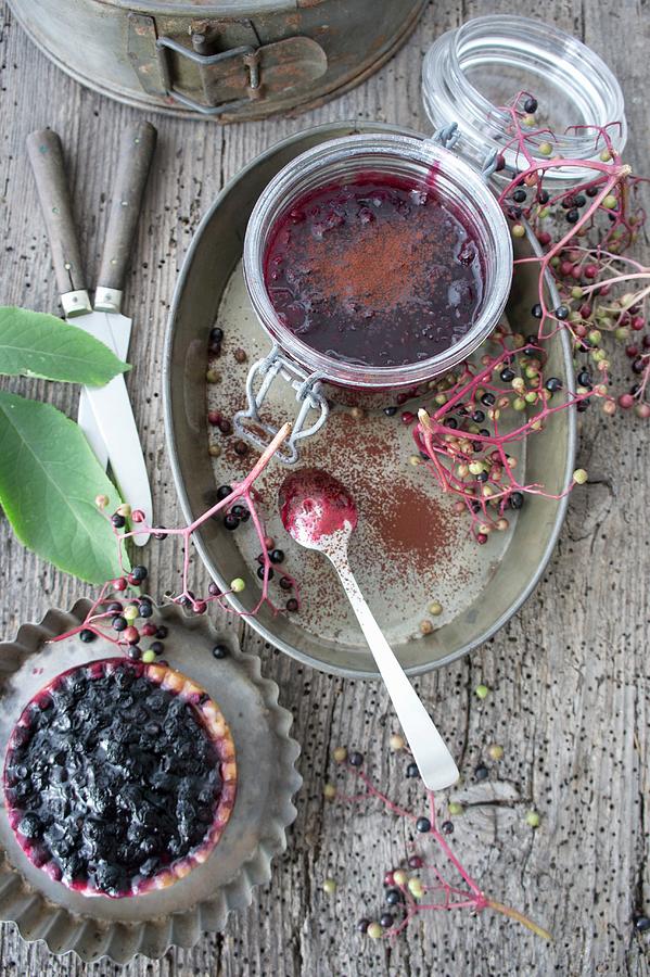 A Blueberry And Elderberry Tartlet And Blueberry Jelly With Cocoa Powder Photograph by Martina Schindler
