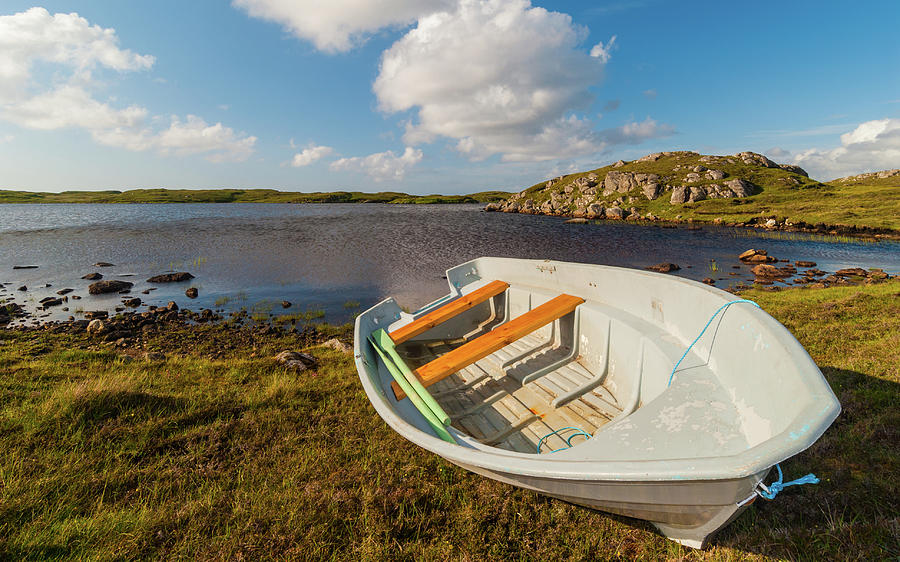 A boat drawn up on the shore at Shawbost, Isle of Lewis Photograph by David Ross