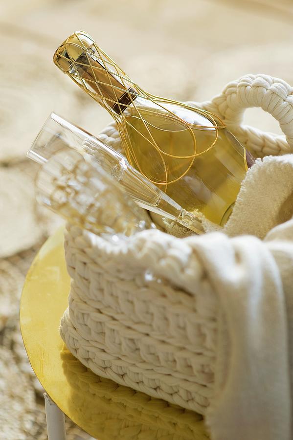 A Bottle Of Champagne With Two Glasses In A Crocheted Basket Photograph by Frederic Vasseur