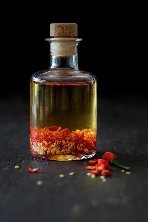 A Bottle Of Homemade Chilli Oil Photograph by Jan Wischnewski