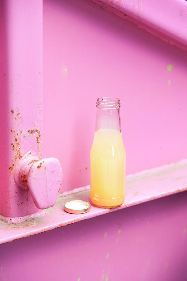 A Bottle Of Homemade Peach Lemonade With Basil Photograph by Manuela Rther