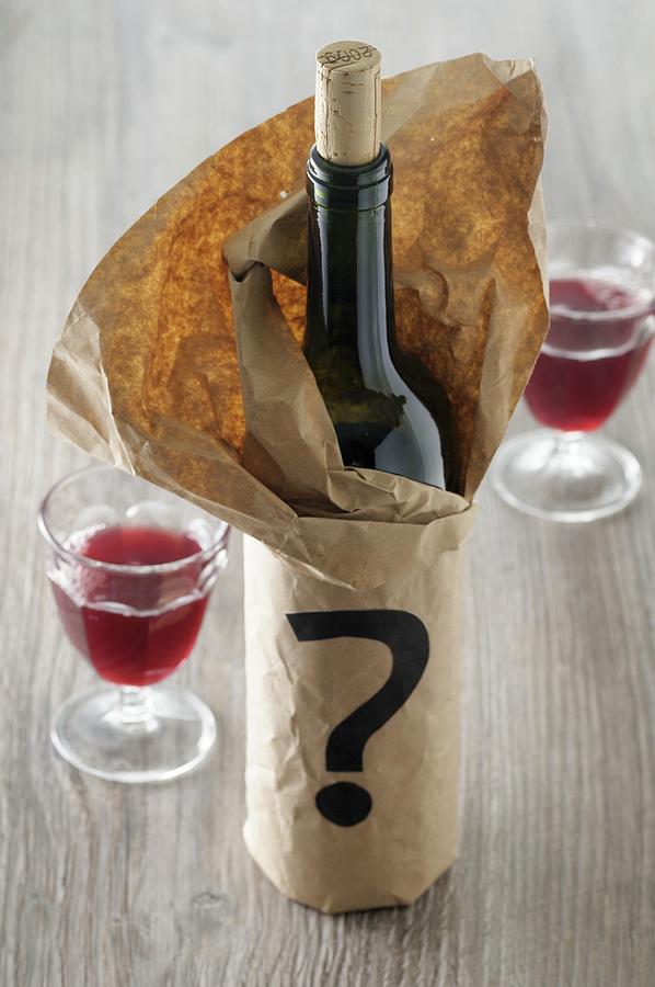 A Bottle Of Red Wine In A Paper Bag With A Question Mark Photograph by Jean-christophe Riou
