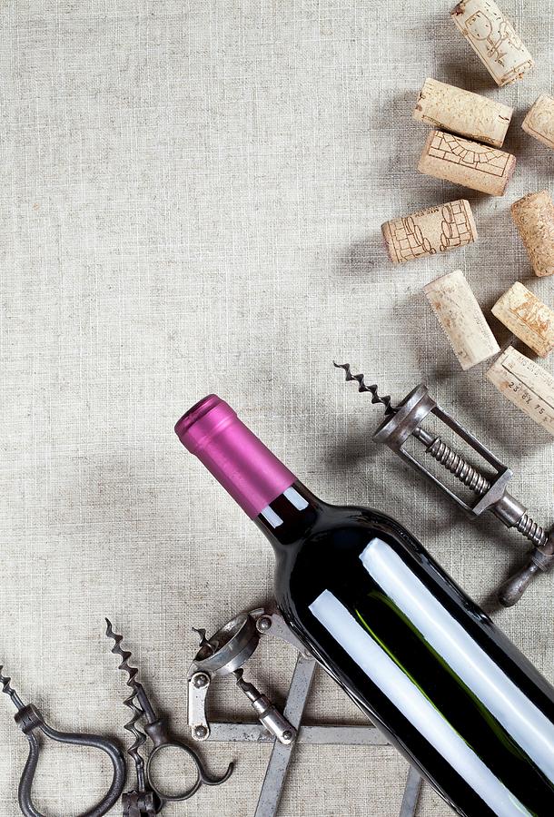 A Bottle Of Red Wine, Old Corkscrews And Wine Corks Photograph by Worytko, Pawel