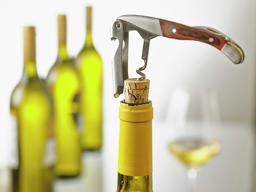 A Bottle Of White Wine Being Opened With A Sommelier Knife Photograph by Foto4food