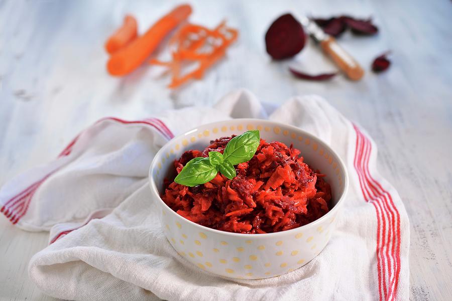 A Bowl Of Beetroot Salad With Carrots And Basil Leaves Photograph by Mariola Streim