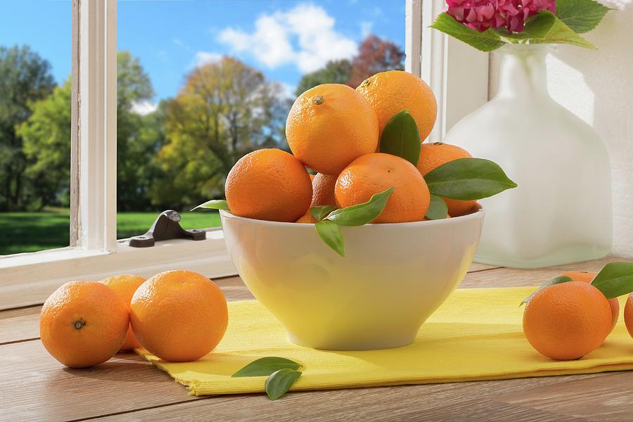 A Bowl Of Mandarins On A Table By A Window Photograph by Brian Enright