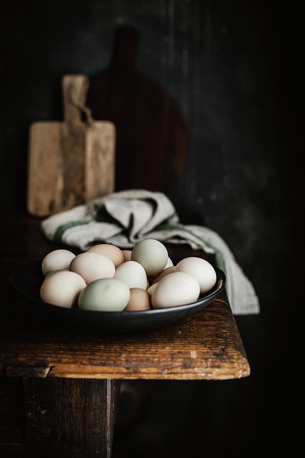 A Bowl Of Naturally Dyed Eggs On A Wooden Table Photograph by Justina Ramanauskiene