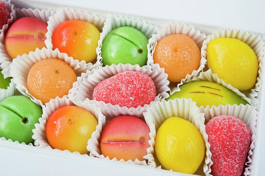 A Box Of Coloured Yellow, Green, Orange And Red Marzipan Fruit Sweets For Christmas Photograph by Burgess, Linda