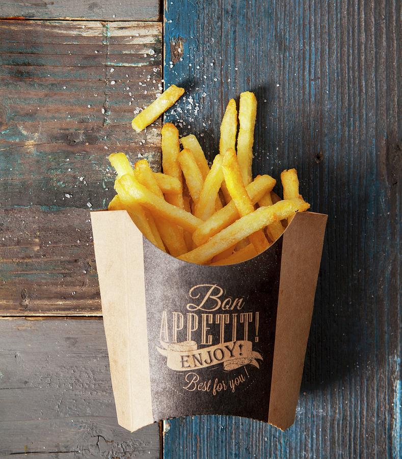 A Box Of Golden French Fries Sprinkled With Salt Photograph by Stacy Grant