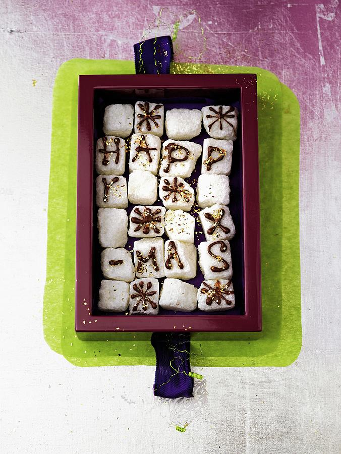 A Box Of Sweet Greetings sugar Cubes Decorated With The Words Happy X-mas In Chocolate Photograph by Jalag / Julia Hoersch