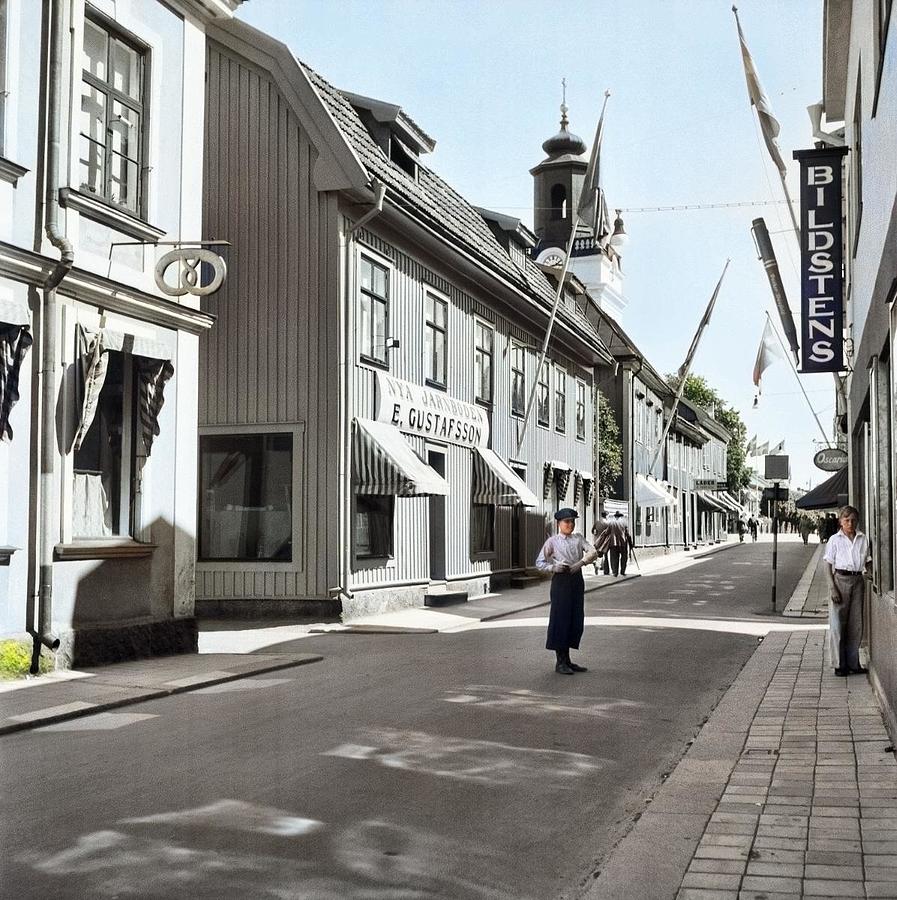 A Boy Standing In Norra Storgatan  North High Street  With Shops. In The Background The Tower Of Ek Painting
