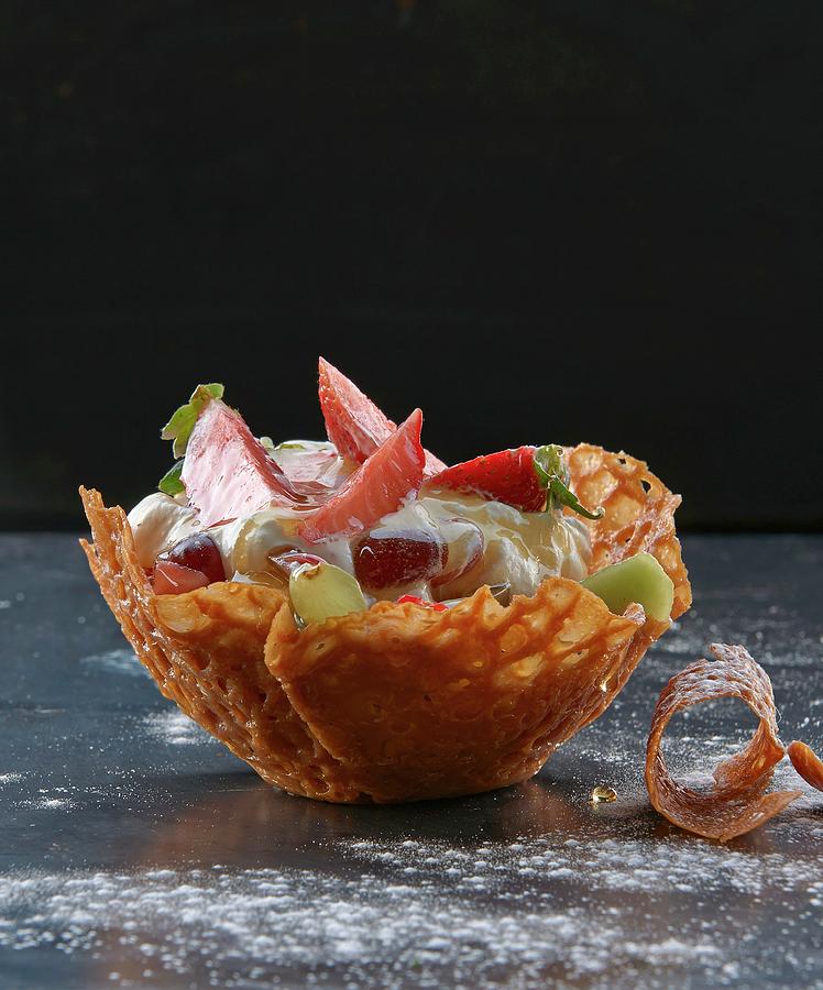 A Brandy Snap Basket With Vanilla Cream Berries And Jelly Photograph by Robbert Koene