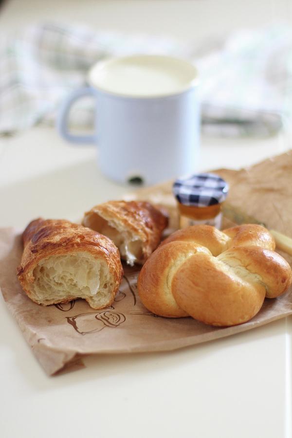 A Bread Roll, A Croissant And A Jar Of Jam On A Paper Bag Photograph by Sylvia E.k Photography
